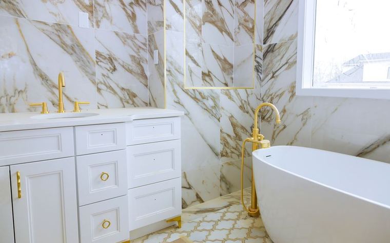 Finished bathroom with marble tiling and a fitted vanity